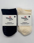 Two pairs of pregnancy compression socks, one navy and one cream, with Maia Mum labels on a light gray background.